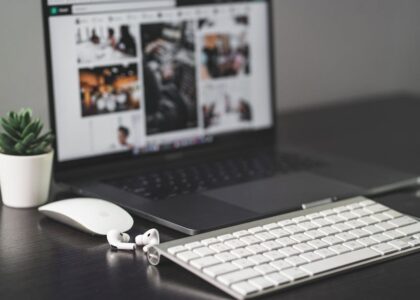 A minimalist desk setup featuring a MacBook and tech gadgets.