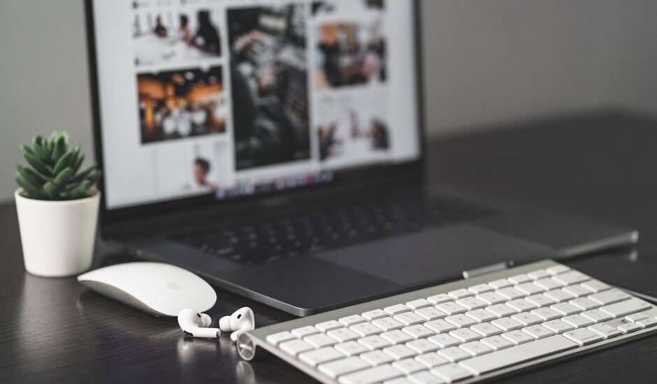A minimalist desk setup featuring a MacBook and tech gadgets.