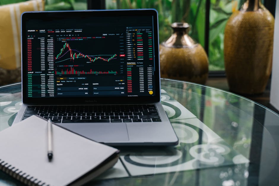 A modern workspace with a laptop and financial charts on a desk