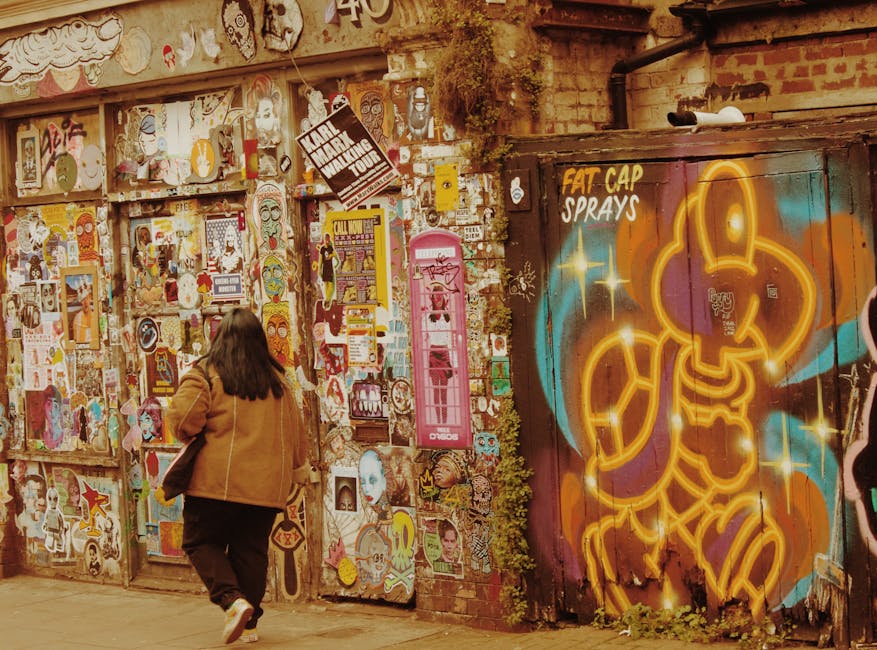 A lively street with colorful graffiti and artistic murals at dusk.