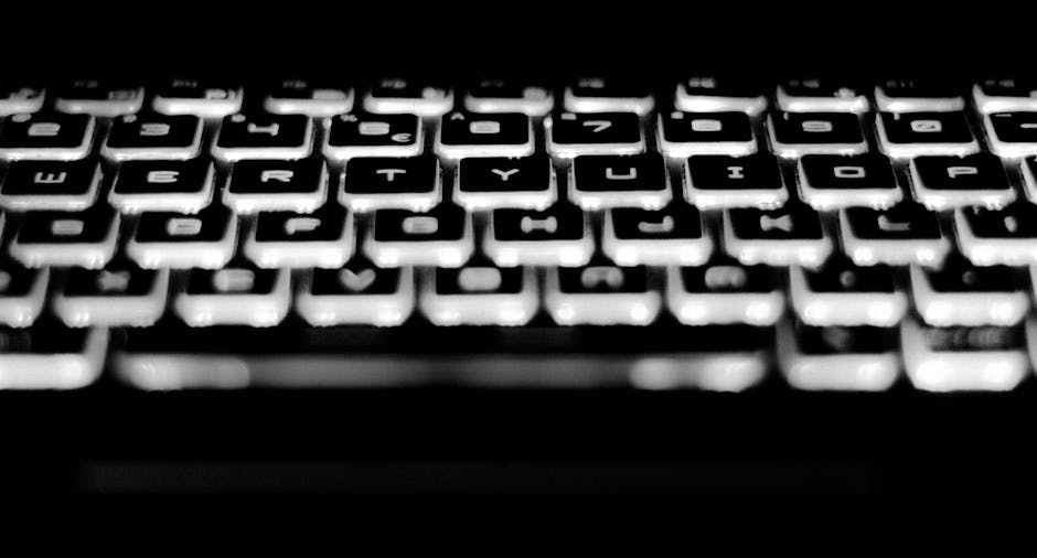 Close-up of a keyboard with fingers ready to type, softly lit