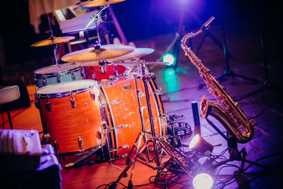 A colorful stage setup with instruments and lights for a performance.