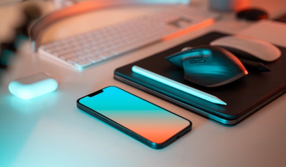A modern workspace featuring a laptop and digital tools on a desk.