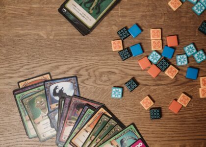 Colorful game elements scattered on a bright classroom surface.