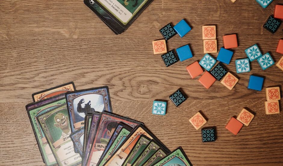 Colorful game elements scattered on a bright classroom surface.