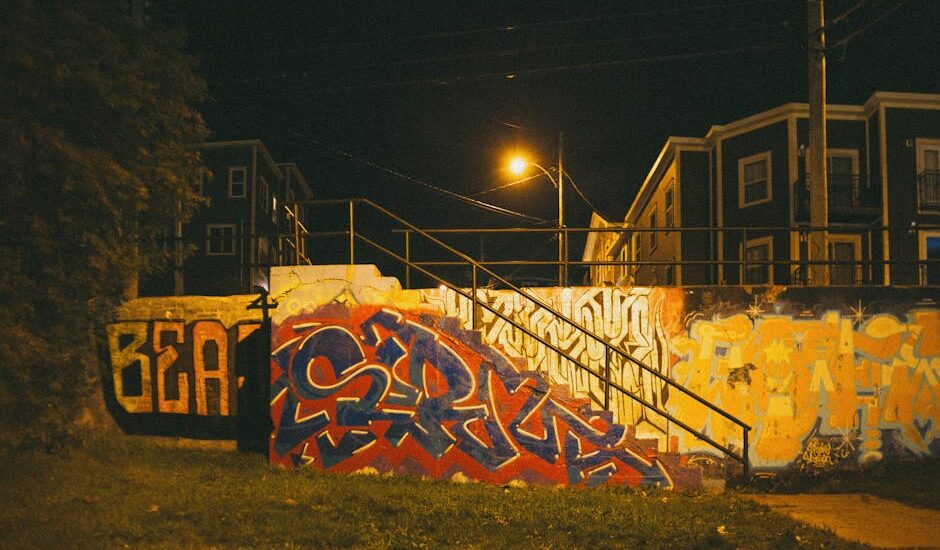 Urban landscape with graffiti art and soft streetlights at dusk.