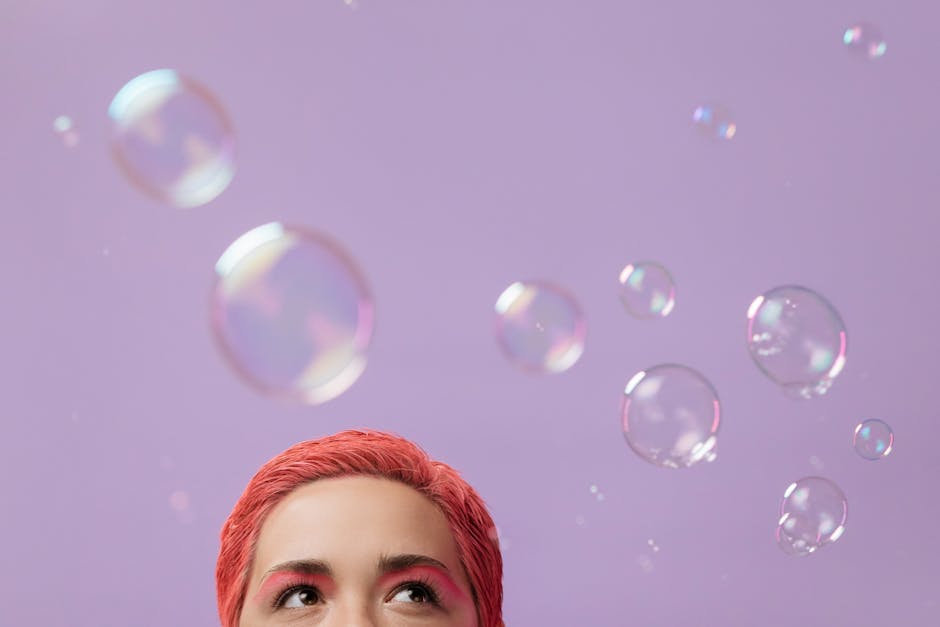Colorful bubbles floating in a pastel sky above a whimsical landscape.