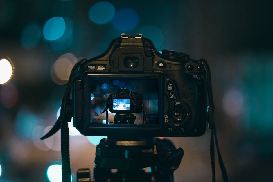 Camera lens focusing on a colorful image on a blurred screen.