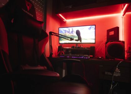 A colorful gaming setup with LED lights and a plush chair.
