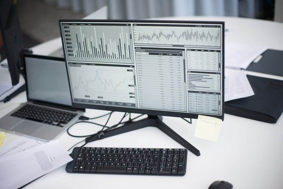 A modern office workspace with a computer and analytics graphs displayed.