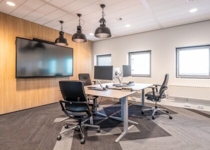 A modern dealership office with digital screens and sleek furniture.