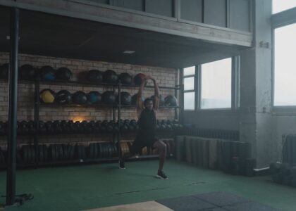 A vibrant gym filled with fitness equipment and blurred exercising silhouettes.