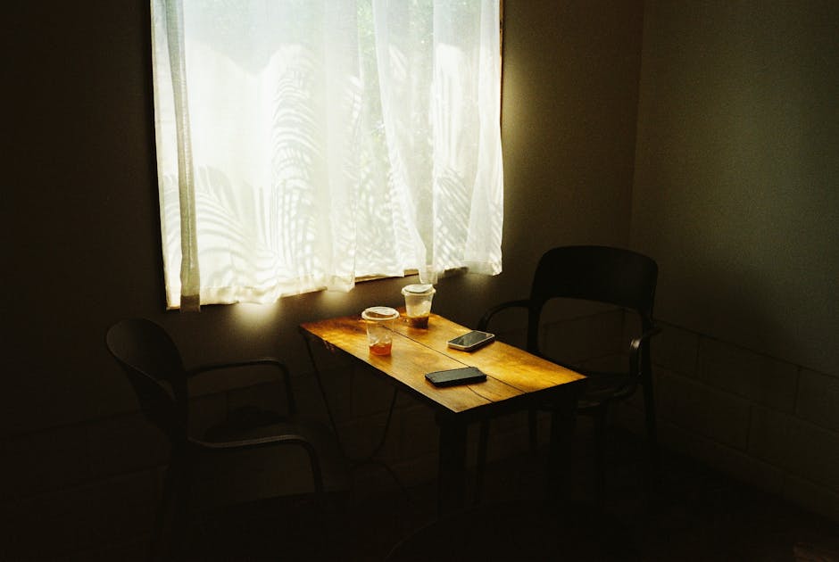 A warm coffee shop scene with two mugs on a wooden table
