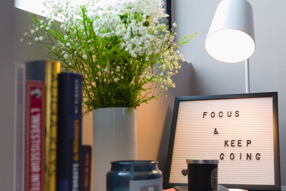 A modern workspace with fitness gear and motivational items on a desk.