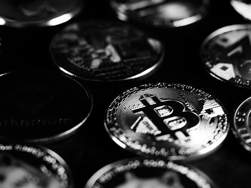 Various cryptocurrency coins on a modern surface under soft lighting.