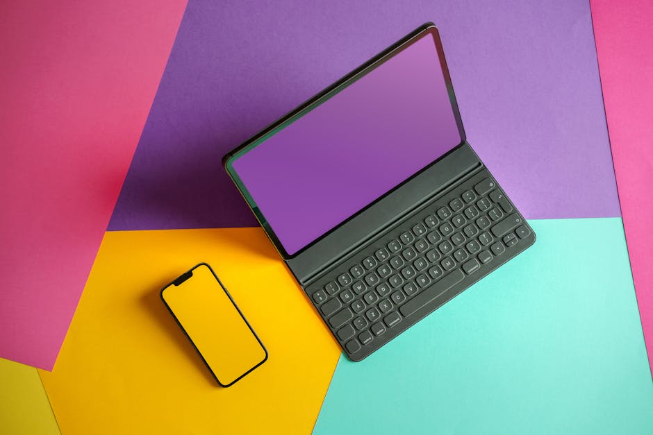A modern digital workspace featuring a laptop and abstract shapes.