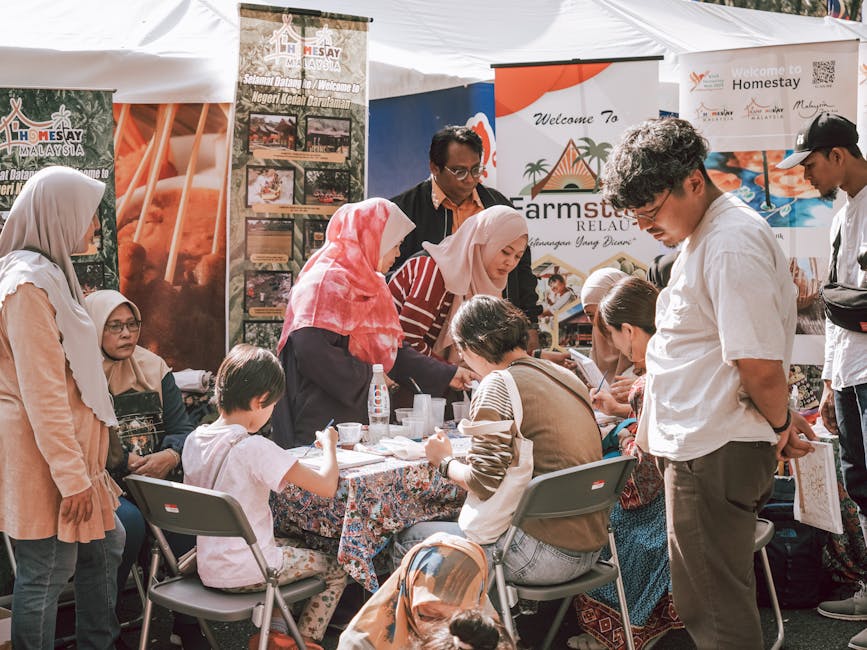 A lively health fair with people interacting and educational booths present.
