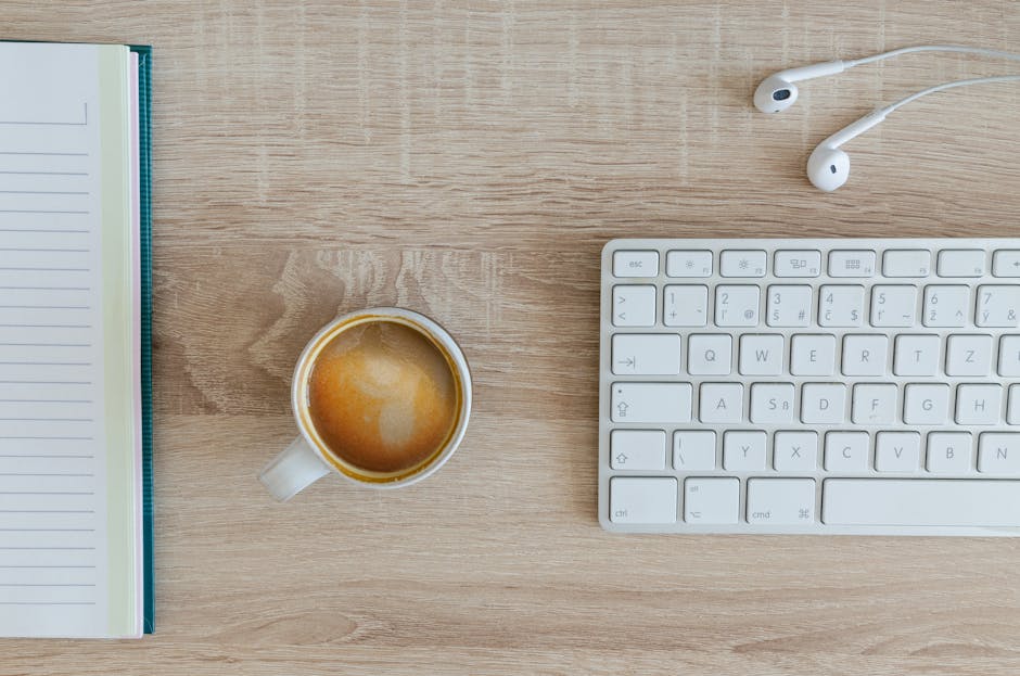 A cozy workspace with a laptop and coffee cup on a wooden desk.