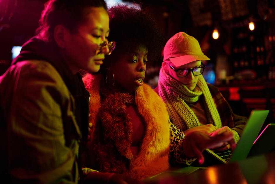 A group of coders working together in a warm café setting.