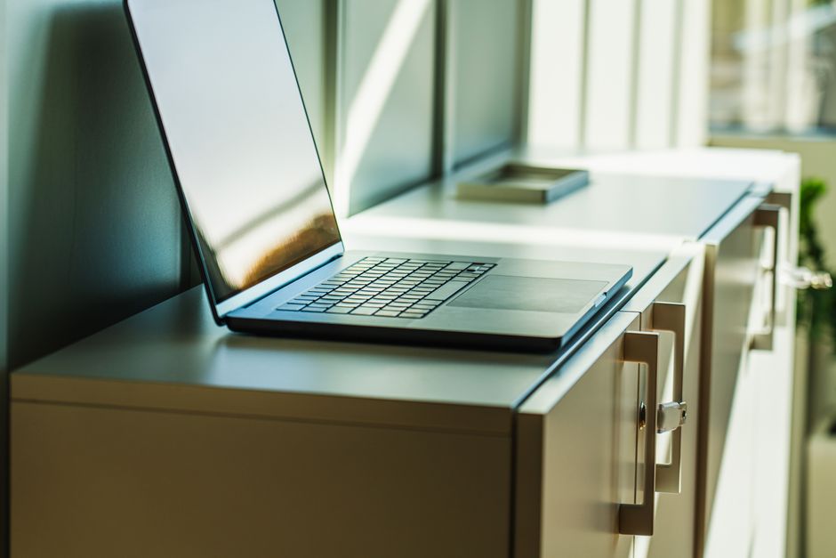 Laptop desk scene with magnifying glass and branching file icons