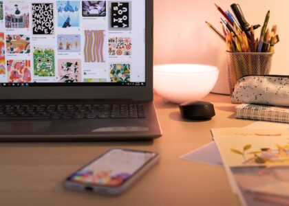 A bright workspace with design tools and colorful graphics displayed