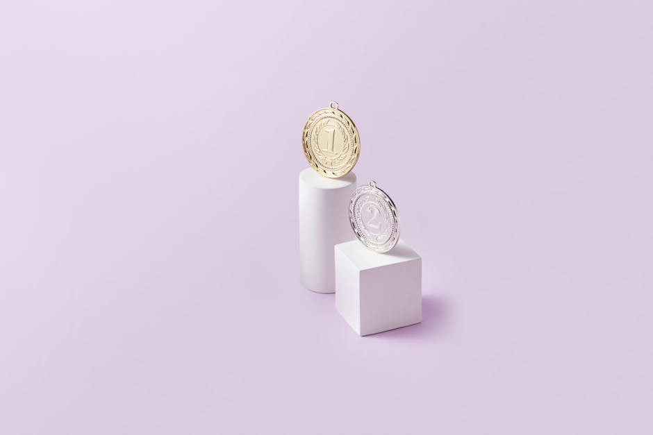 A trophy, medal, and football arranged on a sleek surface