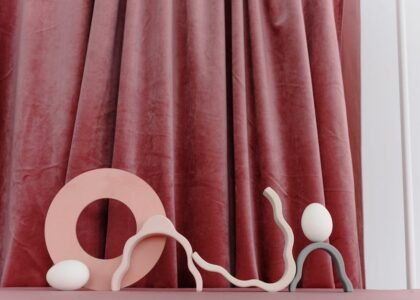 A minimalist still life with abstract shapes in soft pastel colors.