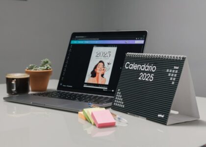 A modern workspace with a laptop, coffee cup, and potted plant.