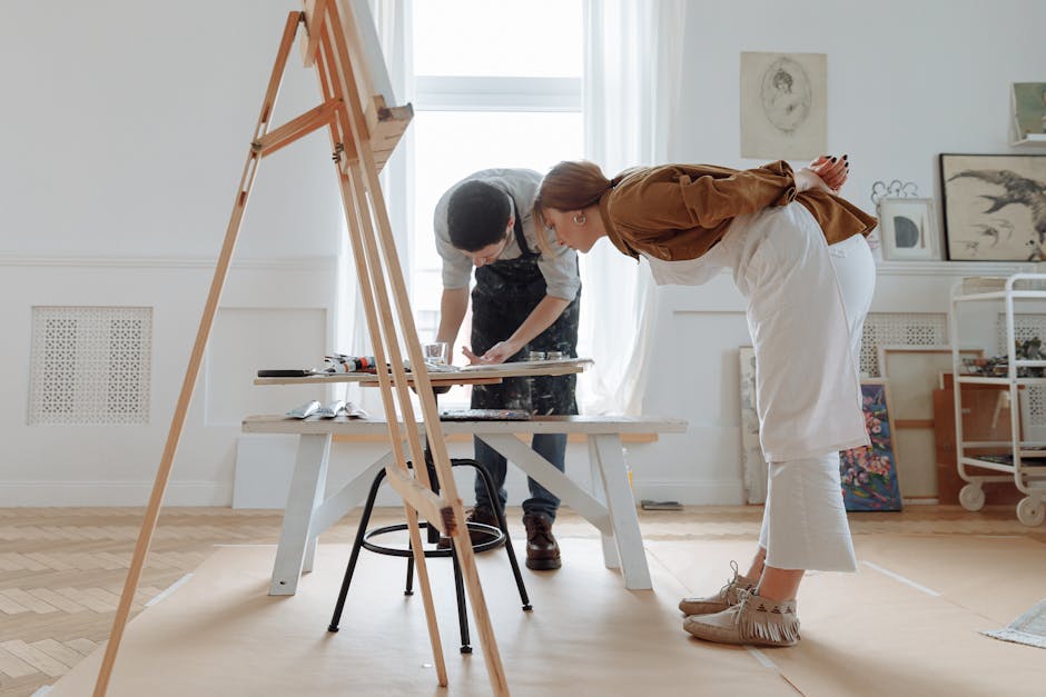 An artist's studio with colorful paint splashes and creative tools