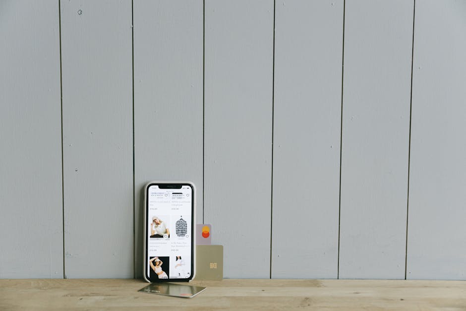 Smartphone with loyalty cards, wristbands, and collectible objects on a table