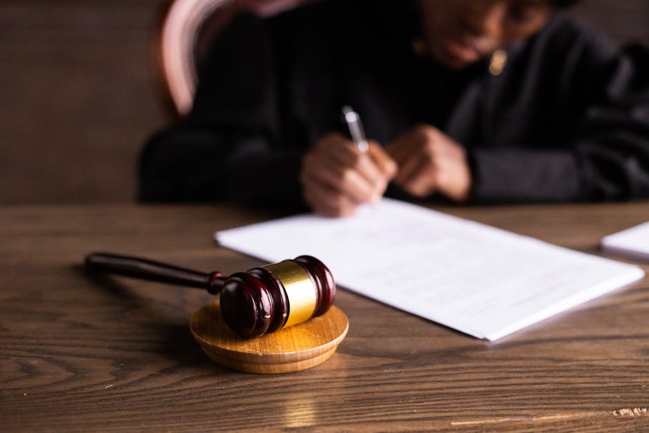 A legal document with a gavel and a temporary phone on a desk