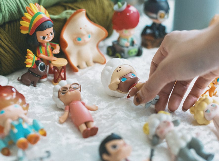 An assortment of colorful doll accessories on a soft pastel background.