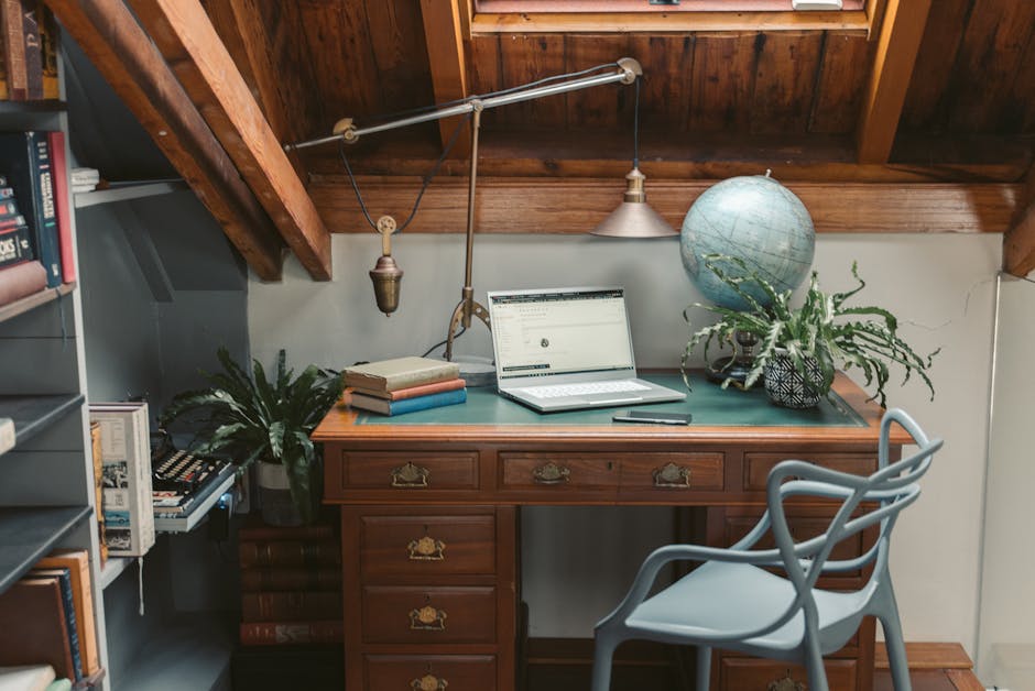 A luxurious desk setup with a globe and gold-plated accessories.