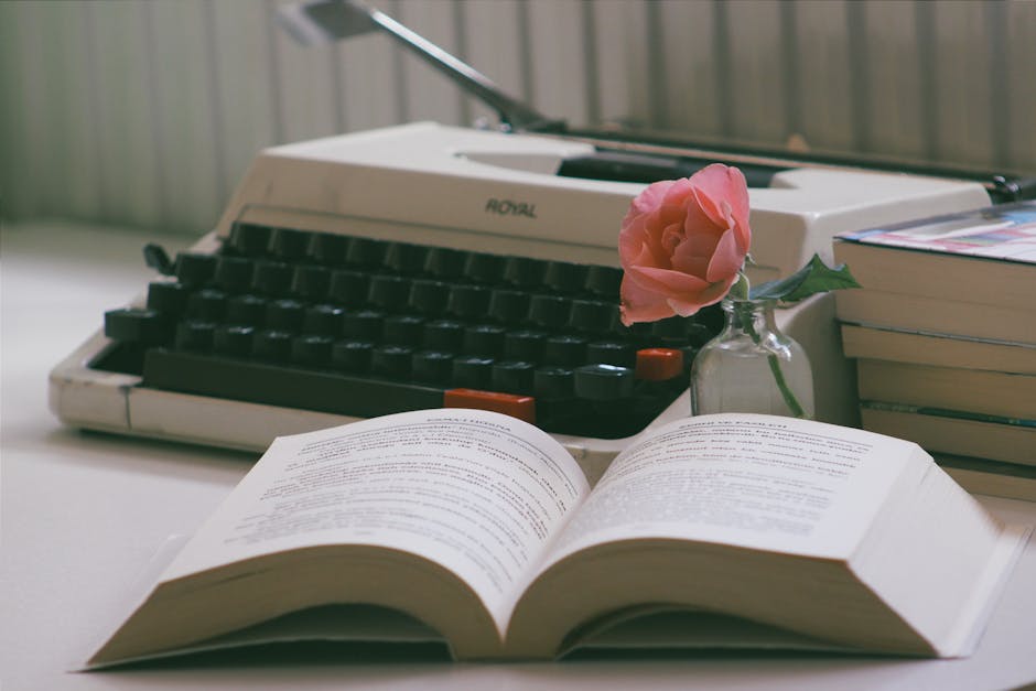 A warm writing nook with a notebook, typewriter, and plants.