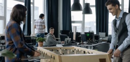 A bright modern office with diverse employees collaborating and using technology.