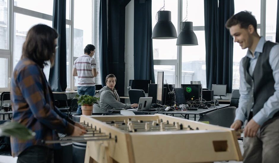 A bright modern office with diverse employees collaborating and using technology.