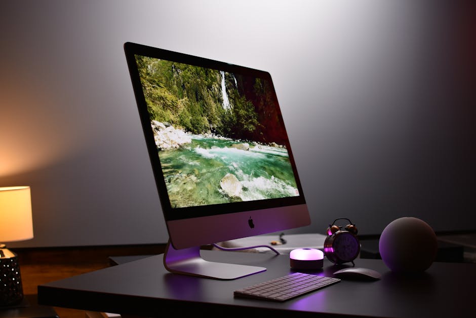 A bright workspace with a computer and digital art tools.