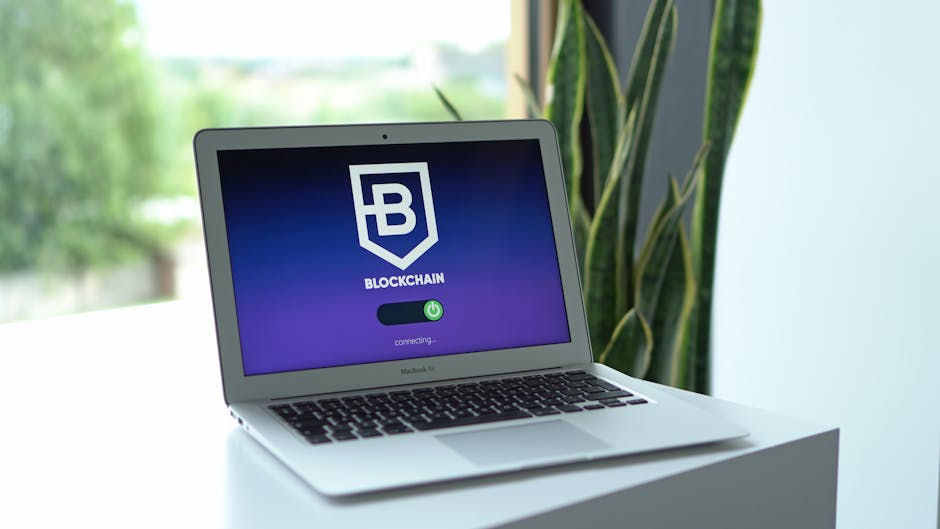 Hardware wallet and key beside a locked vault and blurred laptop