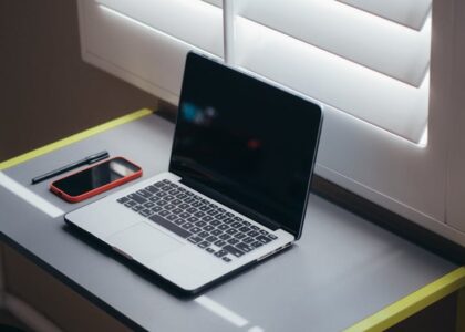 A modern office setup with a laptop and financial documents on a desk.