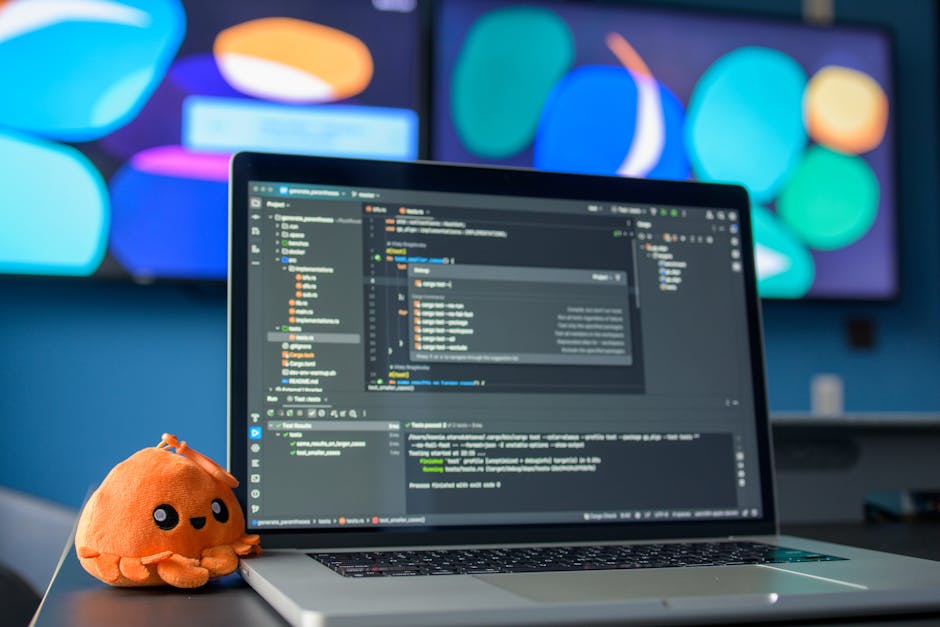 Developer desk with laptop, basketball, and blurred game visuals