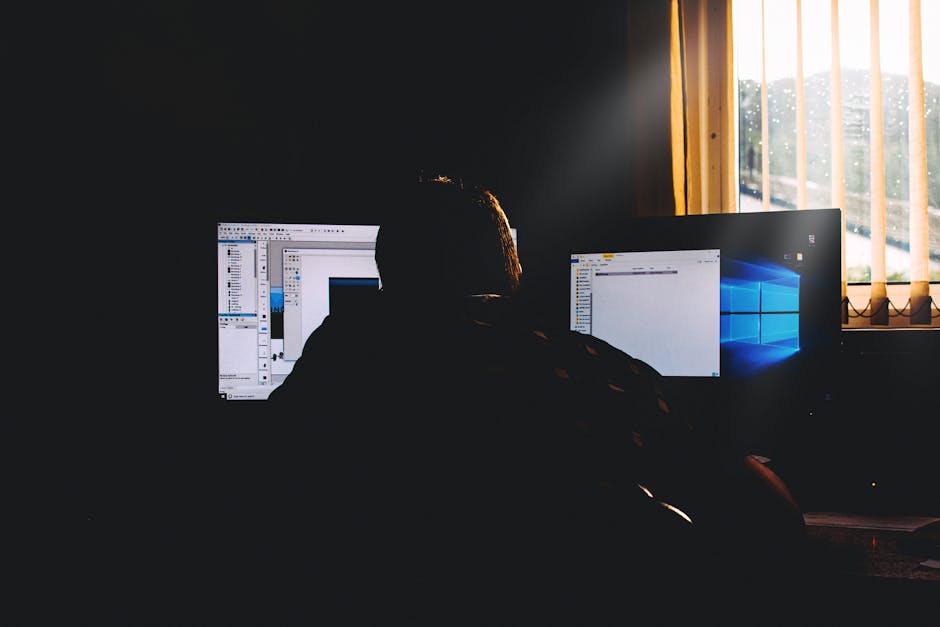 A computer screen with code in a dimly lit room setting.