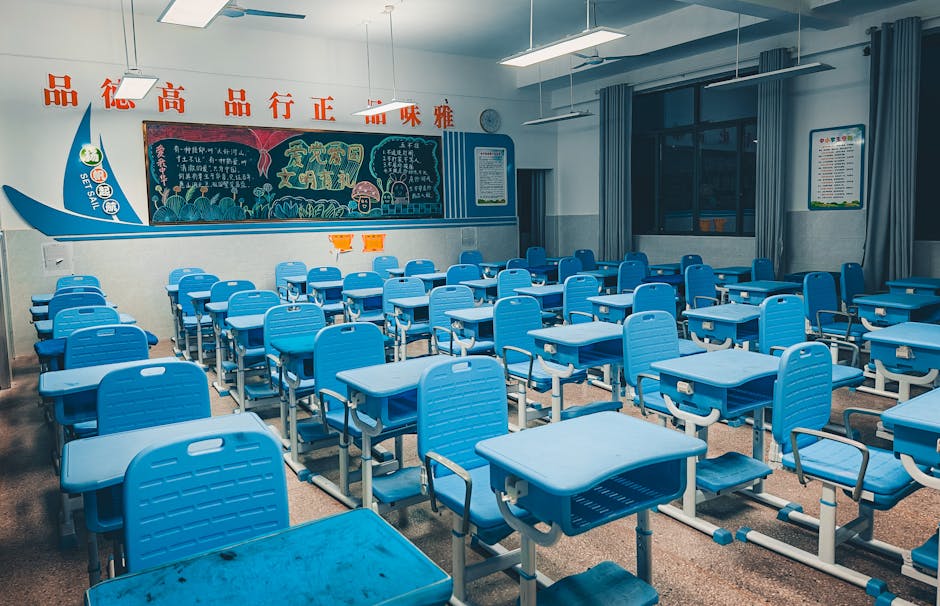 A bright classroom with colorful desks and a chalkboard